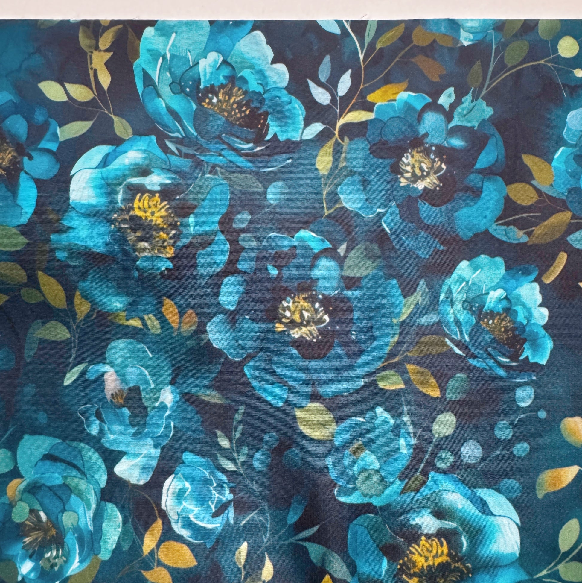Pattern of blue flowers with green leaves on a dark blue background