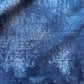 Close-up of textured blue fabric with a blurred background