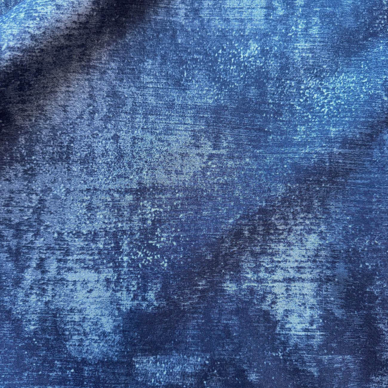 Close-up of textured blue fabric with a blurred background