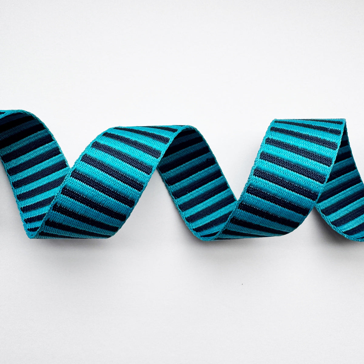 Striped webbing with blue and black stripes on a white background
