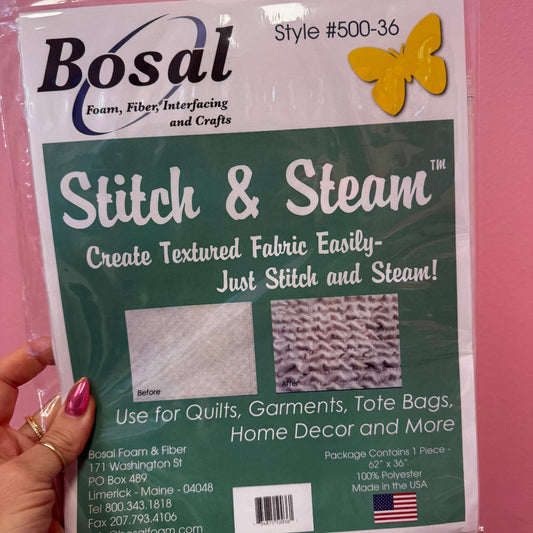 Bosal Stitch & Steam fabric package held by a hand against a pink background