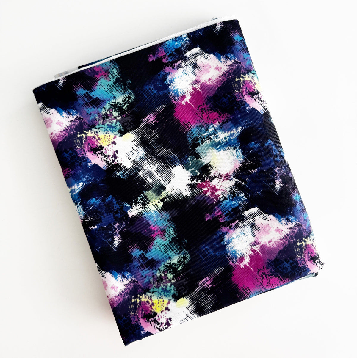 Folded Brushstroke Bonded Nylon fabric with an abstract paint splatter and cosmic paintbrush design in dark blue, pink, and neon accents.