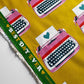 Fabric with typewriter designs and 'Best Day Ever' text on a yellow background