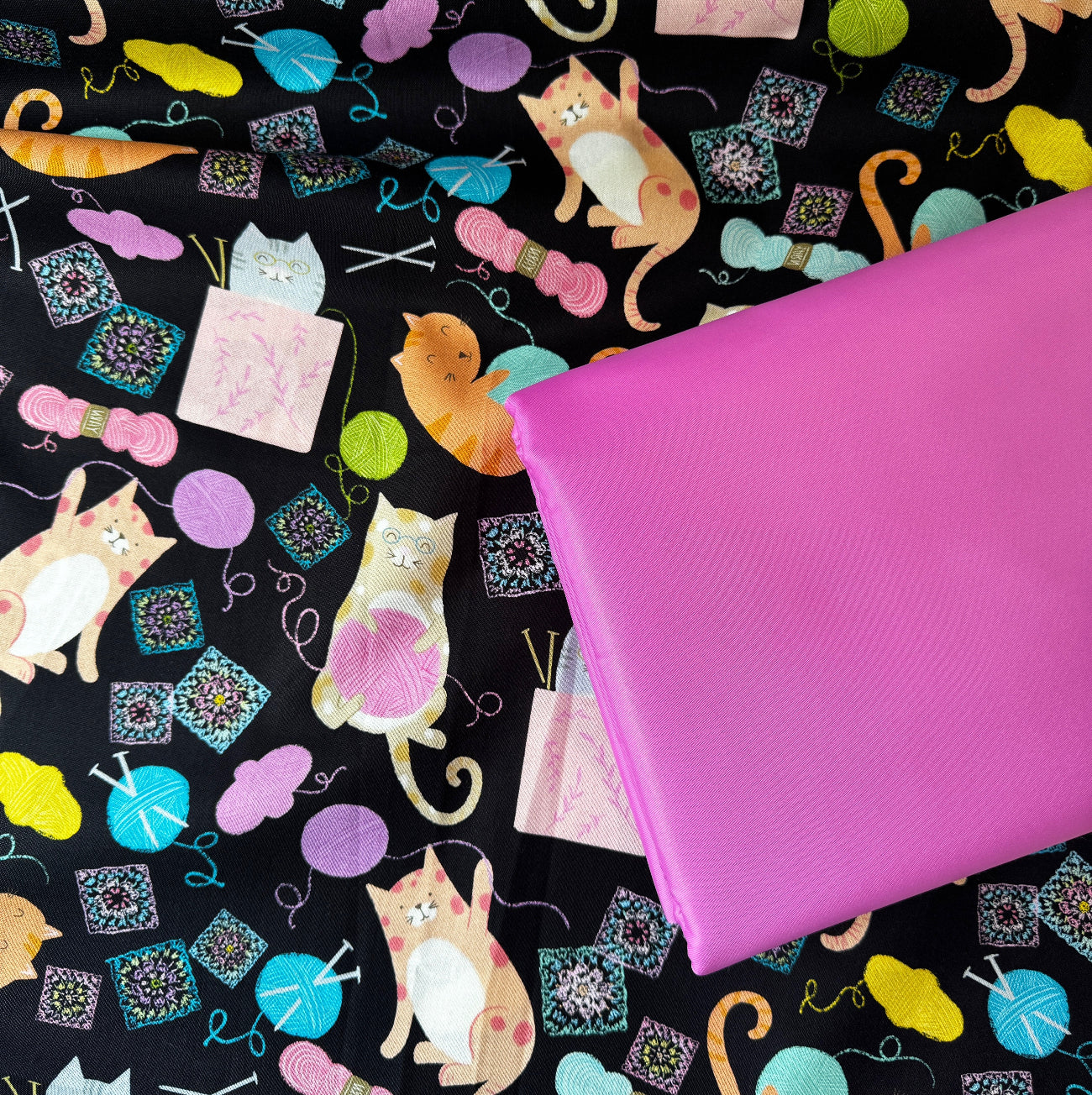 Cat knitting print cotton fabric paired with bright pink bonded nylon for sewing handbags, totes, pouches, wallets, and handmade accessories.