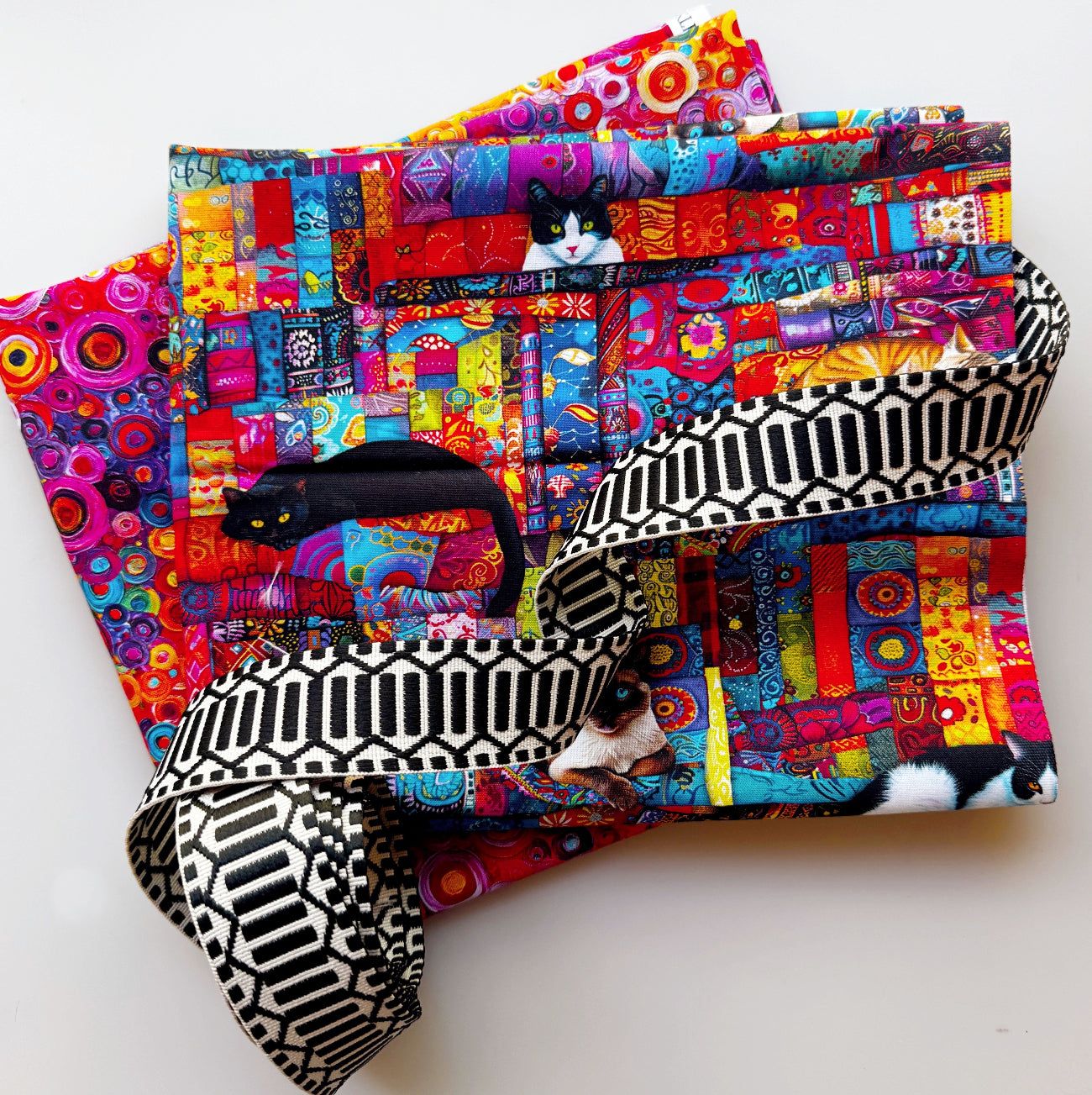 Colorful cat and patchwork cotton fabric paired with black and white geometric webbing, featuring vibrant multicolor designs, perfect for handbags, totes, pouches, backpacks, and sewing projects.