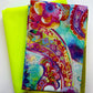 Colorful watercolor paisley print fabric paired with solid neon lime-yellow fabric for quilting and bag making