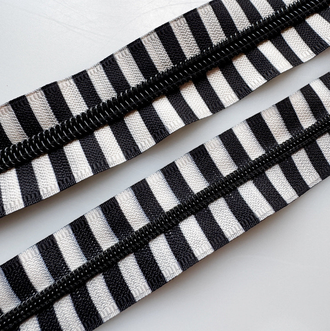 #5 size zipper next to a #3 size zipper