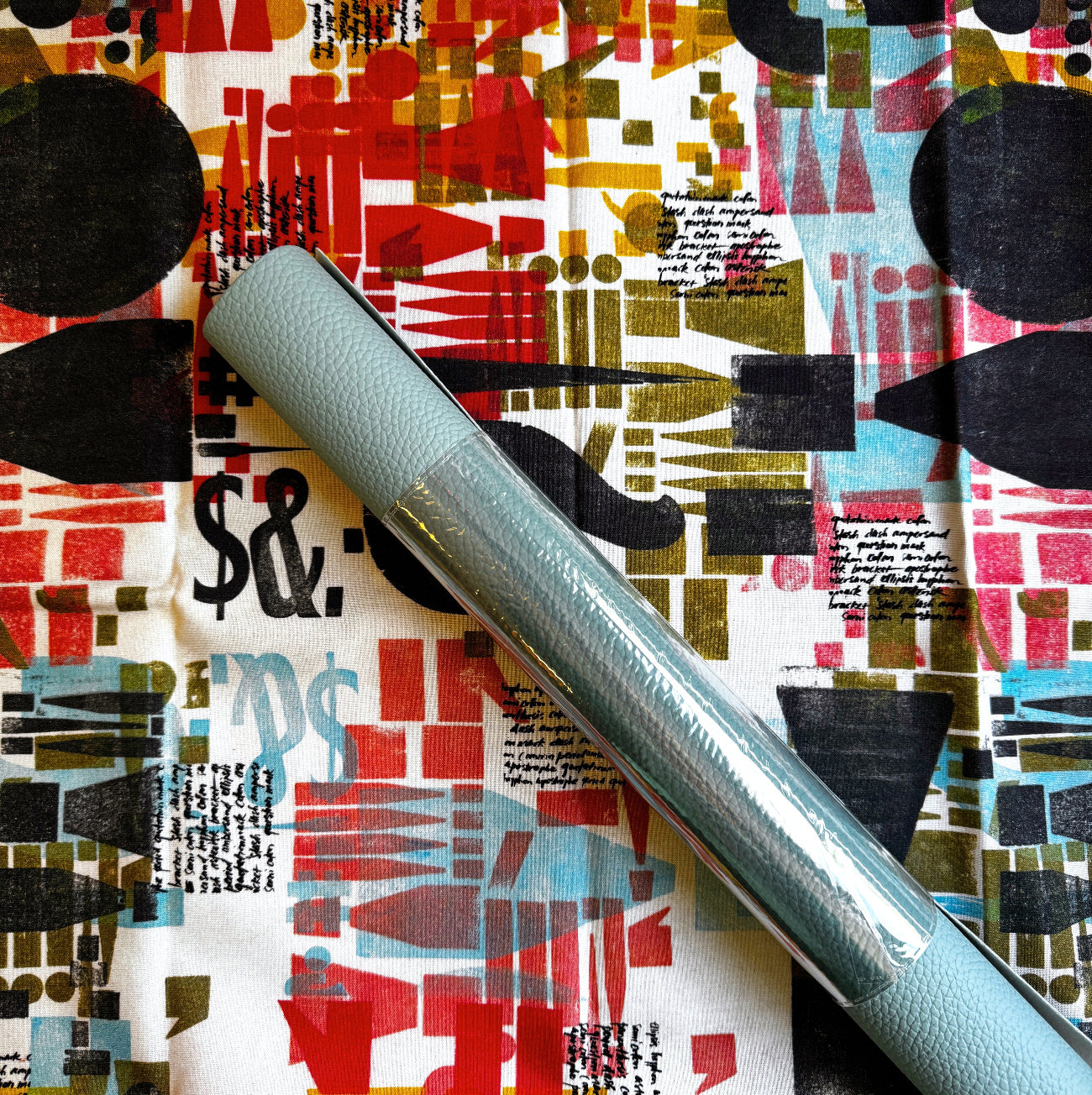 One yard designer cotton fabric bundled with one roll of Butterscotch Moonglow vinyl, perfect for handbags, wallets, and sewing projects.