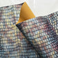 Fabric with a grid pattern in multicolors on a white background