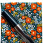 Dark teal fabric with retro orange daisies and small floral print for sewing projects
