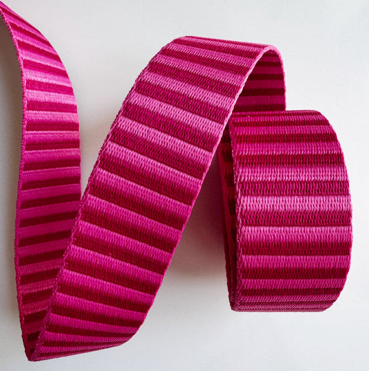Pink strapping with a striped pattern on a white background