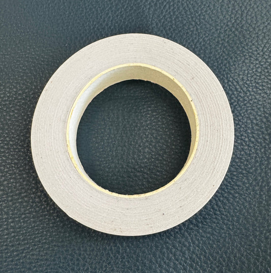 Roll of white tape on a dark textured background