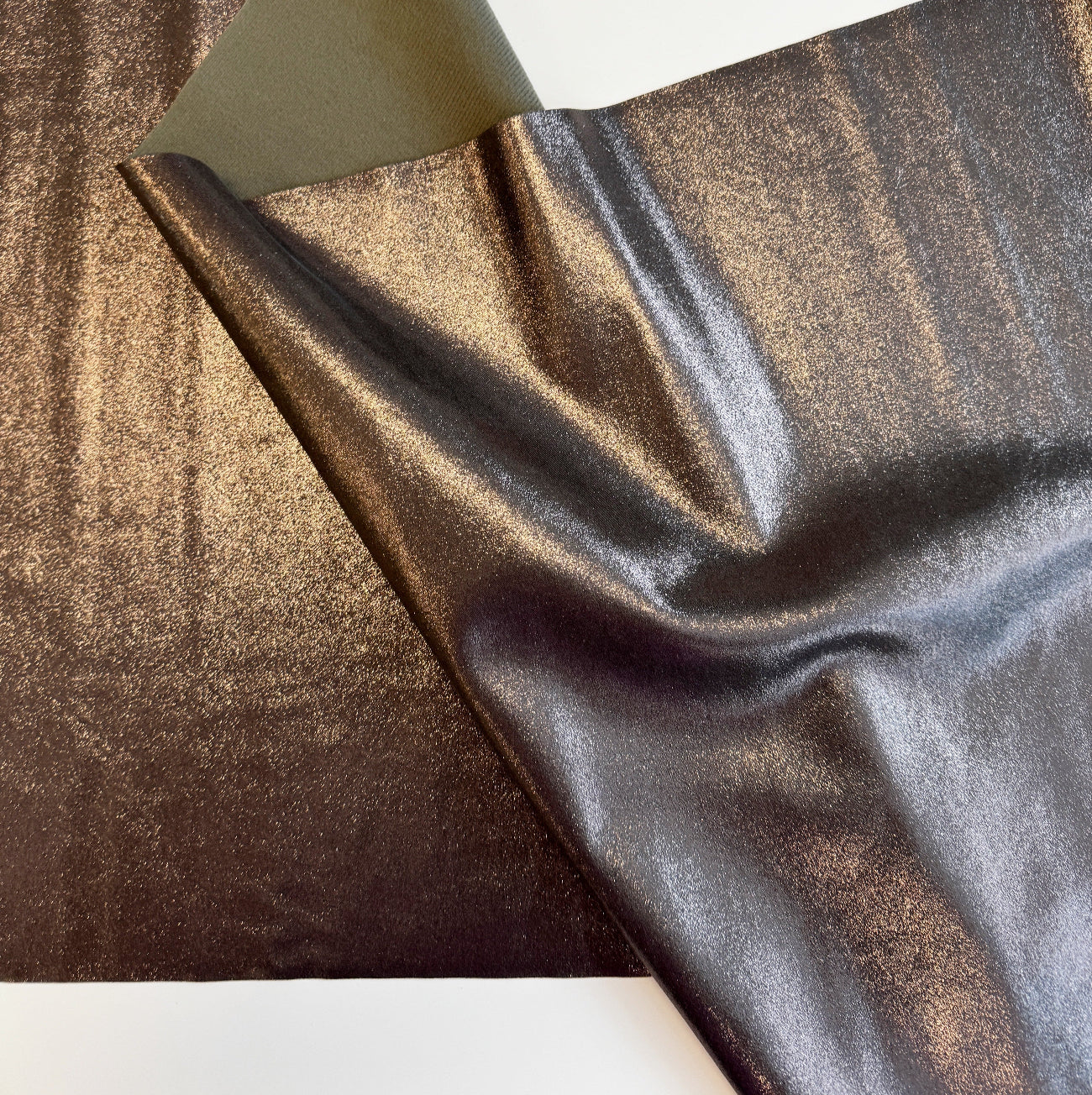 Metallic bronze and pewter fabric sheet with a shiny textured finish
