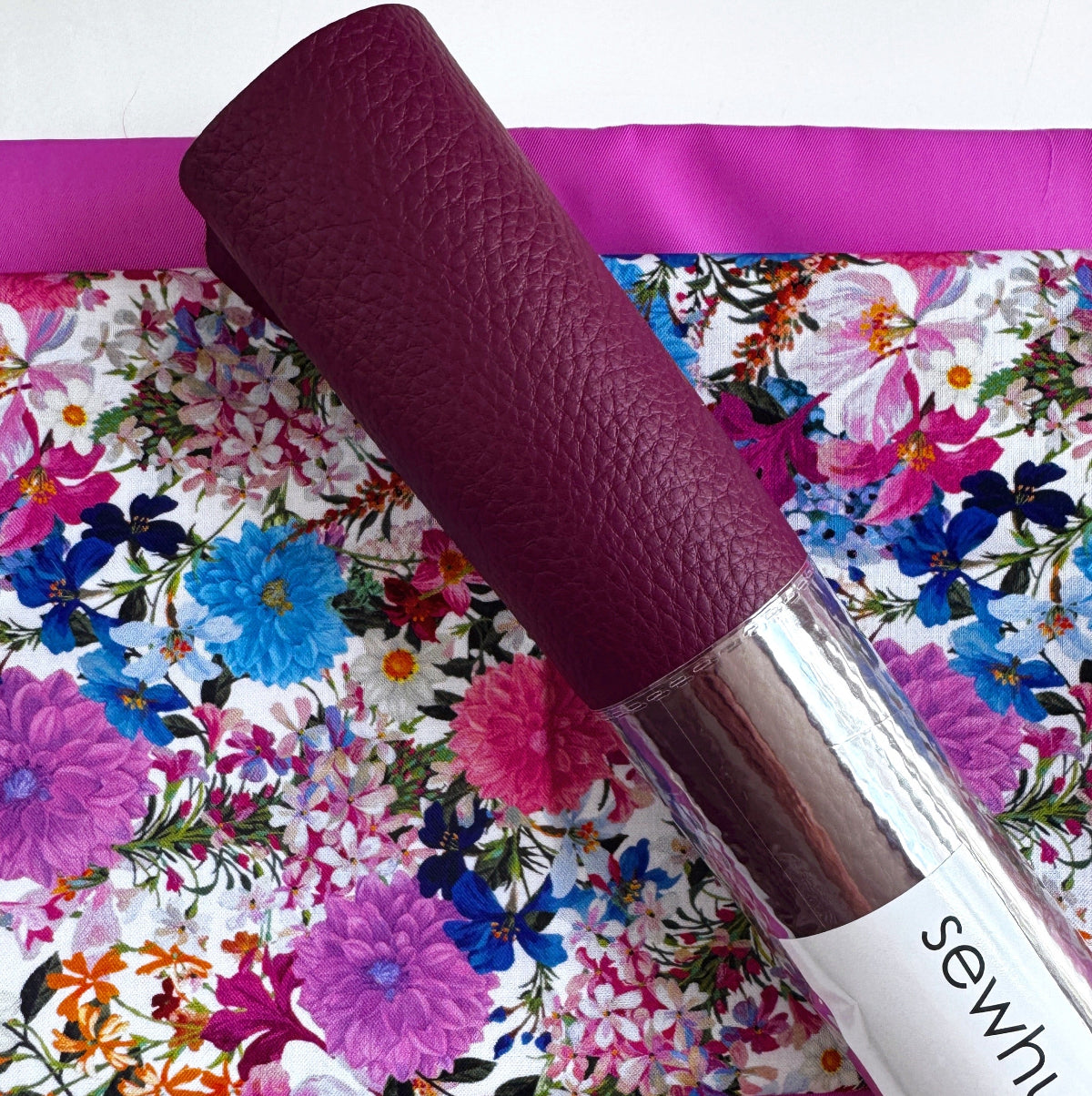 Lipstick with a purple cap on a floral background