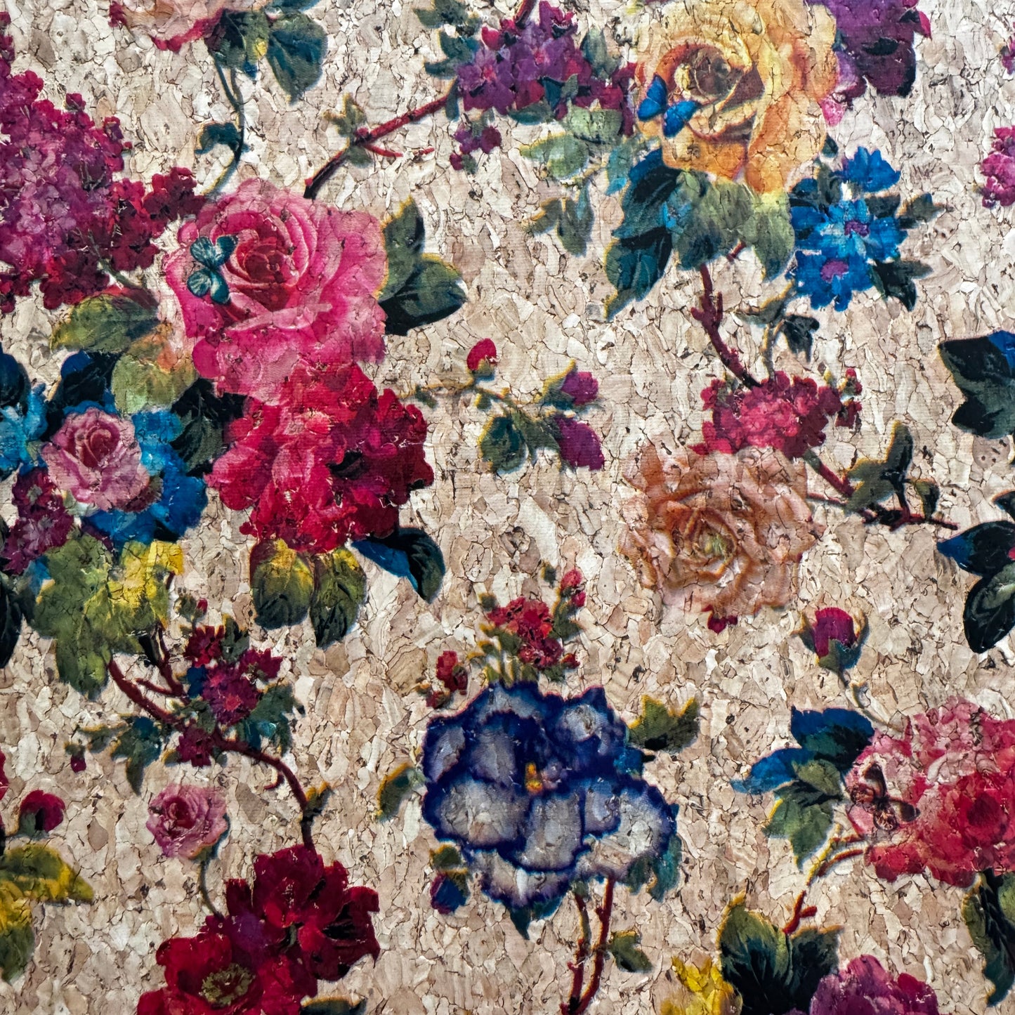 Floral patterned fabric with colorful flowers on a textured beige background