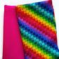 Fuchsia-pink fabric paired with multicolor geometric digital-print fabric in a vibrant pixelated rainbow pattern for bag making
