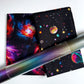 Galaxy and space print cotton fabrics paired with iridescent color-shifting vinyl for sewing handbags, wallets, and handmade accessories.