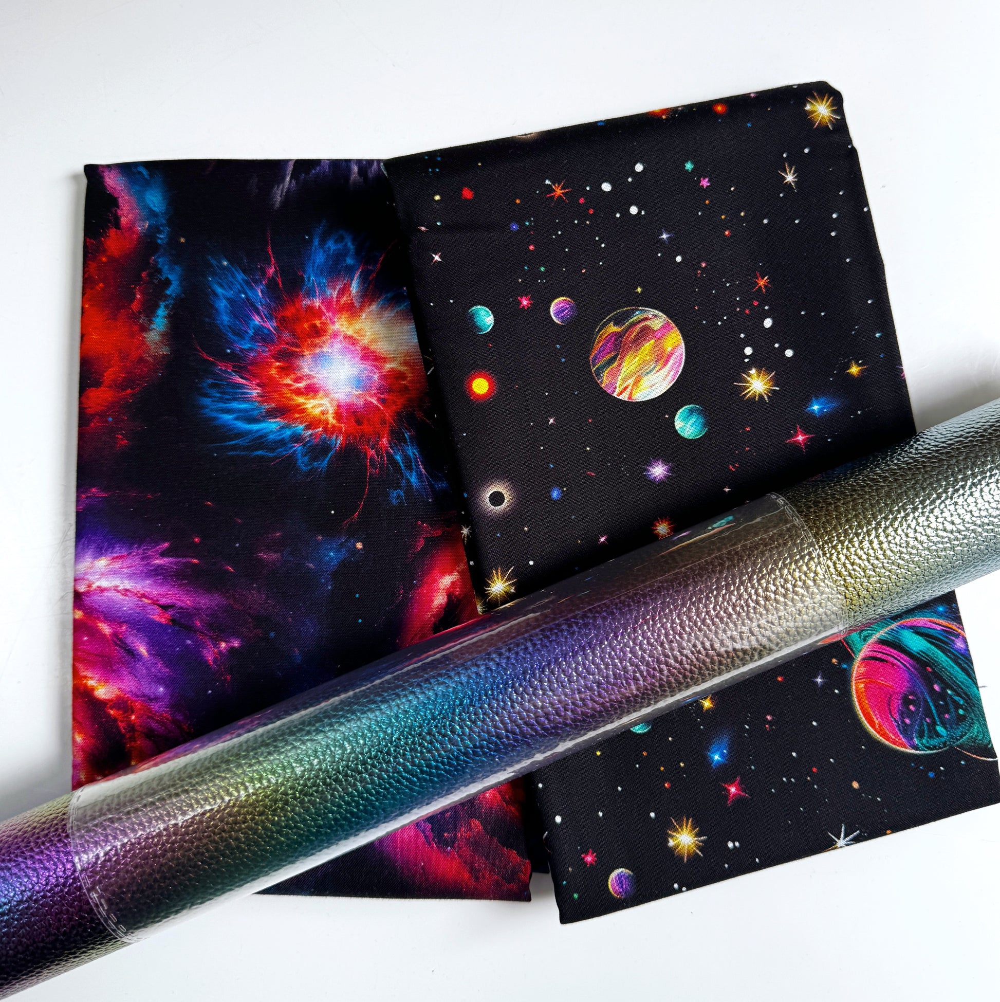 Galaxy and space print cotton fabrics paired with iridescent color-shifting vinyl for sewing handbags, wallets, and handmade accessories.