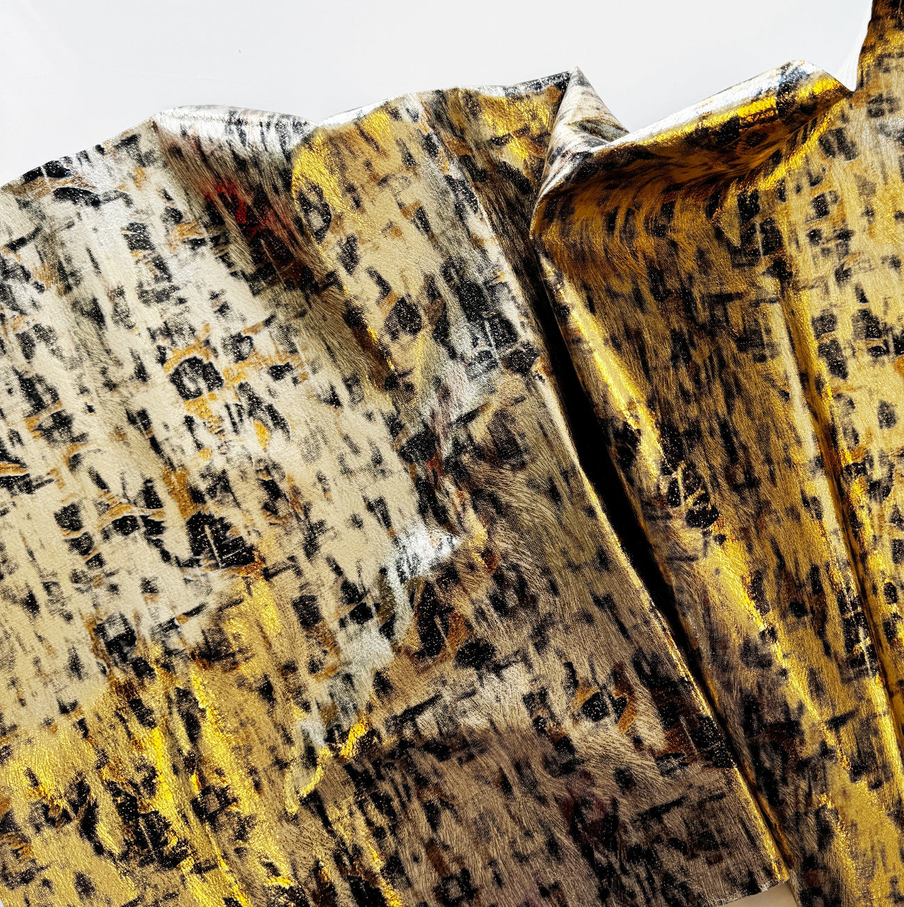 Detailed pattern and texture of gold and black printed fabric material