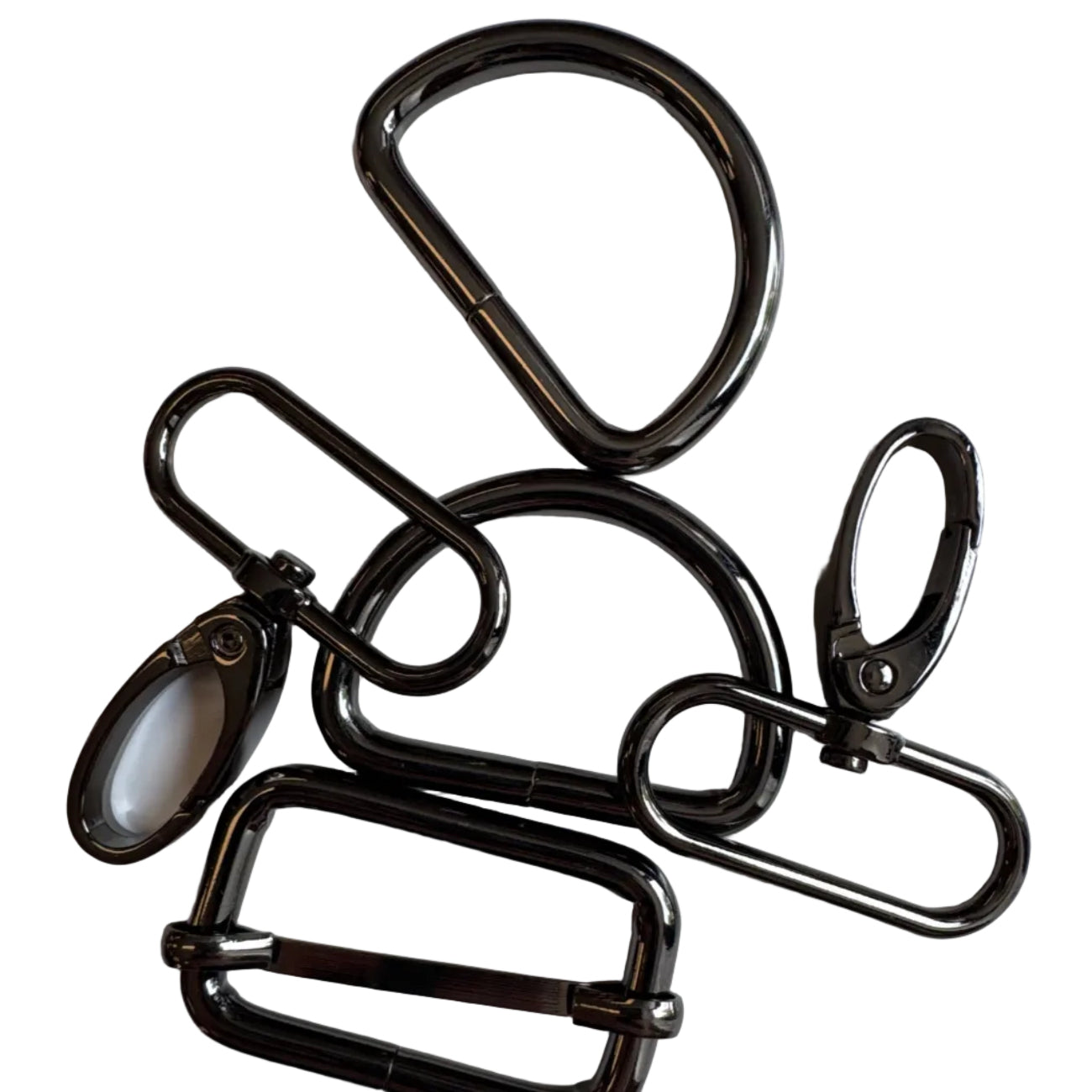 A set of five black metal hardware accessories, including carabiners, clips, and a rectangular buckle, arranged on a plain white surface.