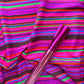 Pink soft vinyl paired with vibrant multicolor striped fabric for bag makin