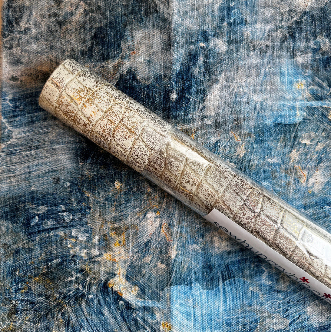 Ivory croc embossed vinyl paired with blue abstract cotton fabric for sewing handbags, totes, wallets, crossbody bags, and handmade accessories.
