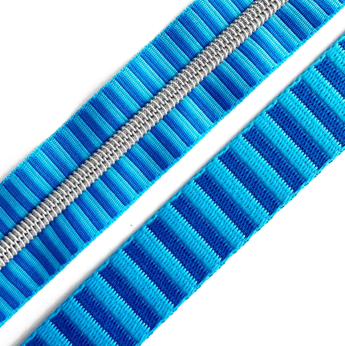 Close-up of a blue zipper with white teeth on a white background