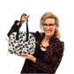 Woman holding a patterned bag against a white background