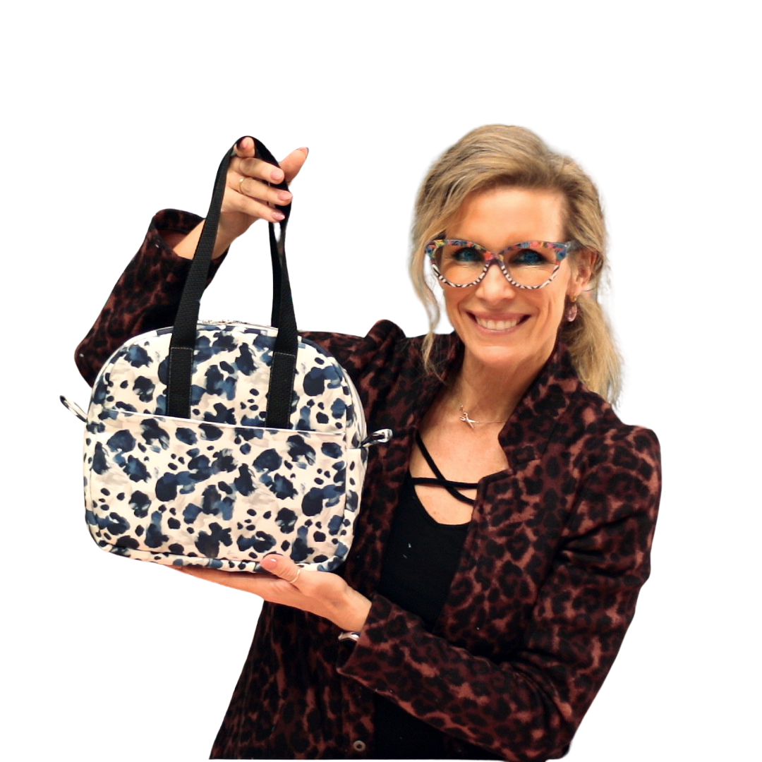 Woman holding a patterned bag against a white background