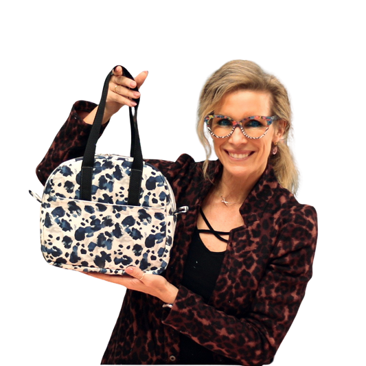 Woman holding a patterned bag against a white background
