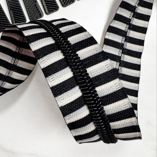 Black and white striped zipperon a white background