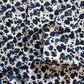 Navy blue and white leopard print fabric on a white background
