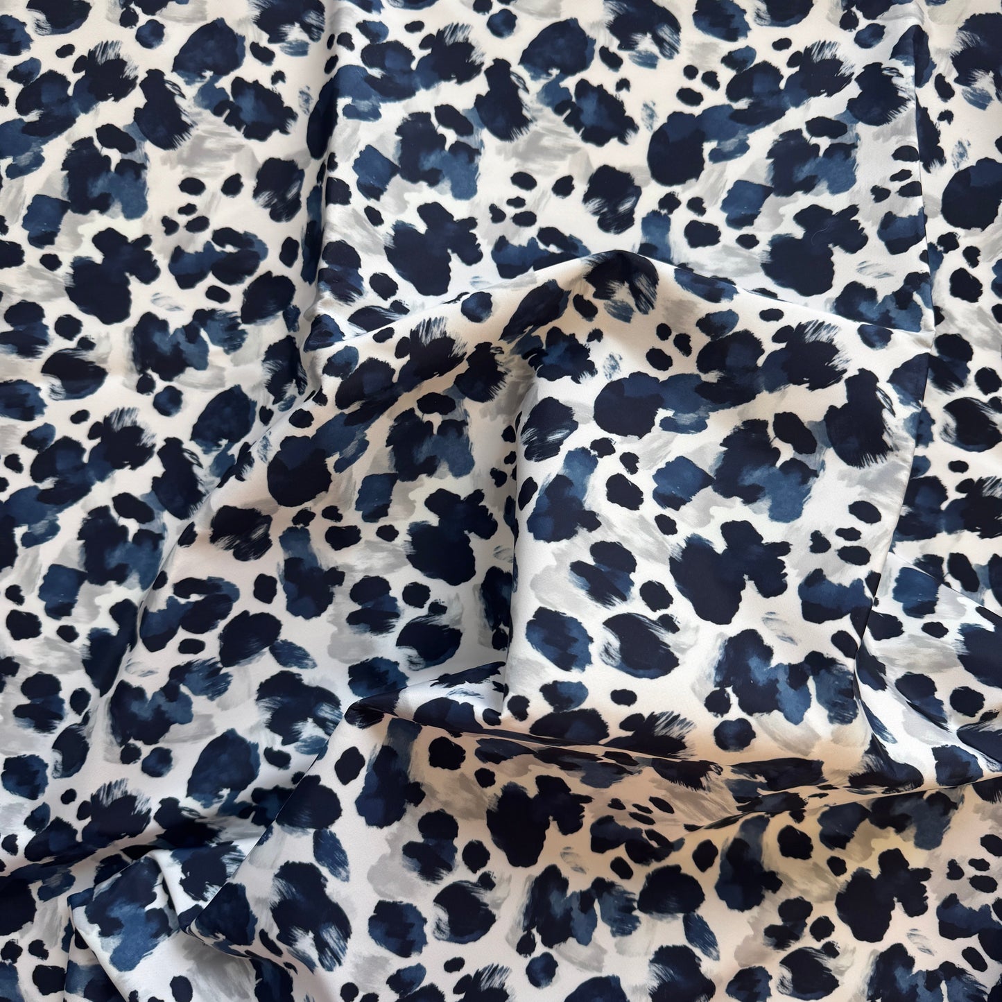 Navy blue and white leopard print fabric on a white background