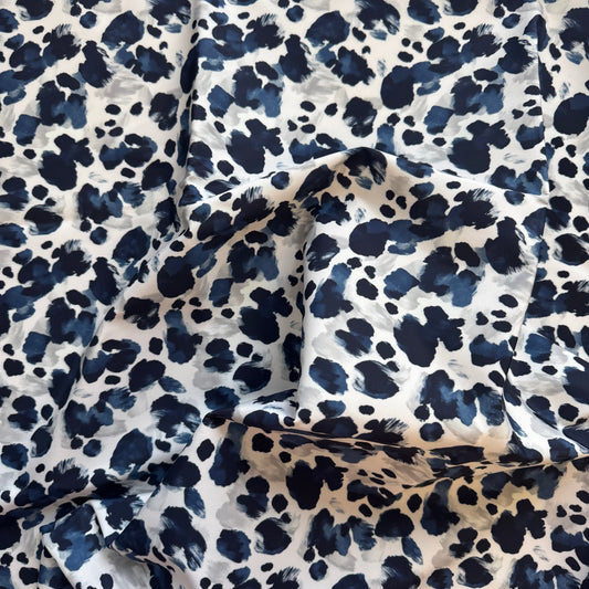 Navy blue and white leopard print fabric on a white background