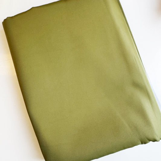 Premium light olive twill bonded nylon fabric with soft texture and durable finish for bag making and sewing projects.