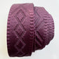 A side view roll of 1.5-inch wide premium jacquard woven webbing strap in a rich merlot wine color featuring an intricate diamond geometric pattern