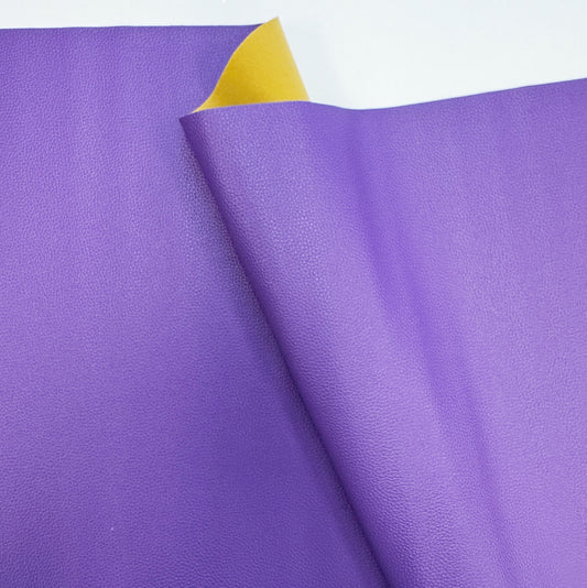  Moonglow purple faux leather vinyl fabric with a textured pebbled surface and a yellow backing for sewing bags and crafts