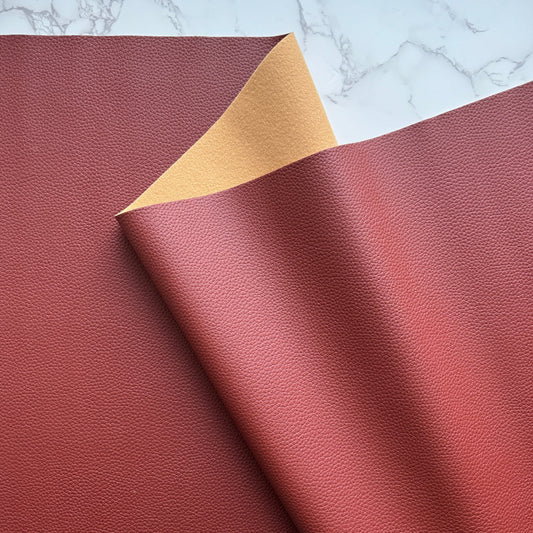 Moonglow Vinyl in red brown, a pebbled faux leather fabric with soft backing