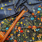 A woodland-themed cotton fabric featuring a dark floral and mushroom print and Toffee Zipper Tape
