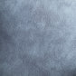 A close-up texture shot of a blue-gray suede or microfiber fabric surface.