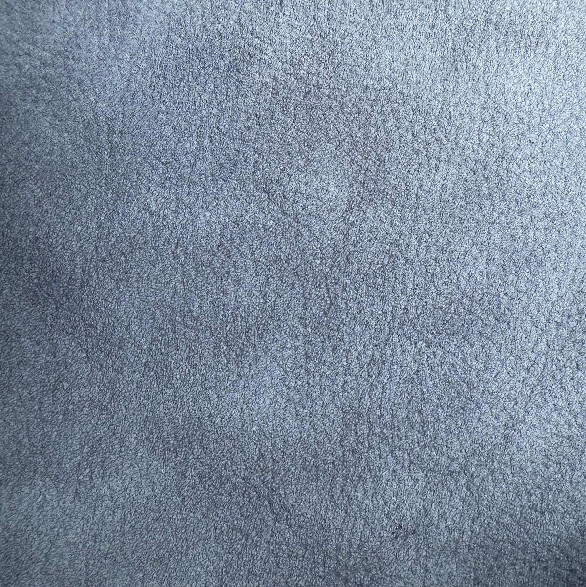 A close-up texture shot of a blue-gray suede or microfiber fabric surface.
