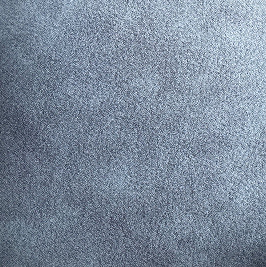 A close-up texture shot of a blue-gray suede or microfiber fabric surface.