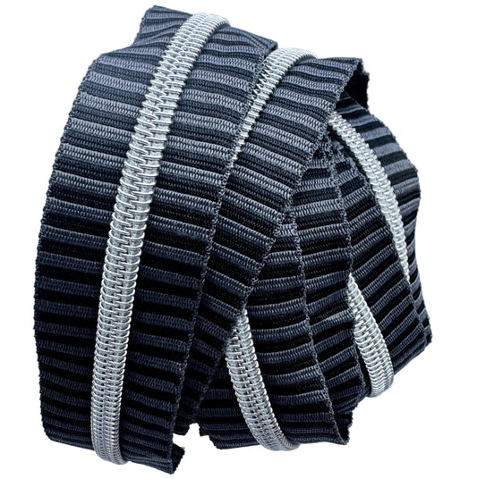 Number 5 continuous nylon coil zipper tape featuring a charcoal grey and black striped jacquard woven pattern with metallic silver teeth, coiled tightly against a white background.