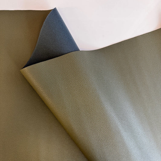 Olive green pebbled faux leather or vinyl fabric, similar to materials like the Moonglow New Olive Faux Leather used for bag making.