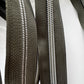 Close-up of black zippers with silver teeth on a white background