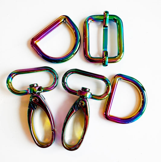 Set of rainbow-colored metal buckles on a white background