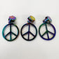 Three iridescent peace sign zipper pulls displayed side-by-side on a plain white background.