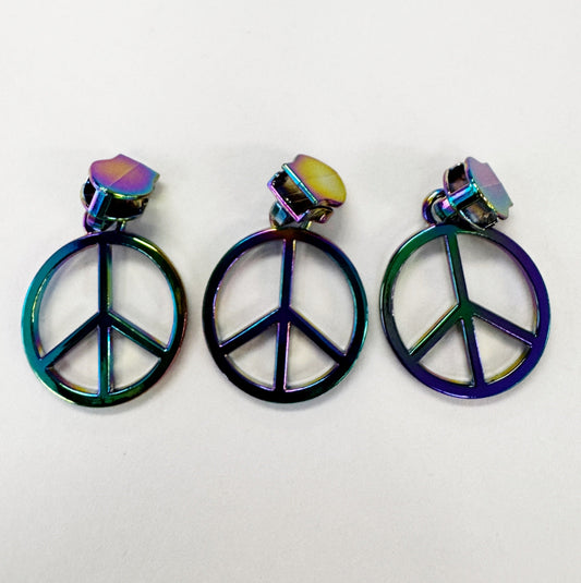 Three iridescent peace sign zipper pulls displayed side-by-side on a plain white background.