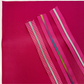 Pink zipper tapes with silver and rainbow zipper teeth displayed on coordinating pink vinyl for sewing handbags, wallets, pouches, and handmade accessories.