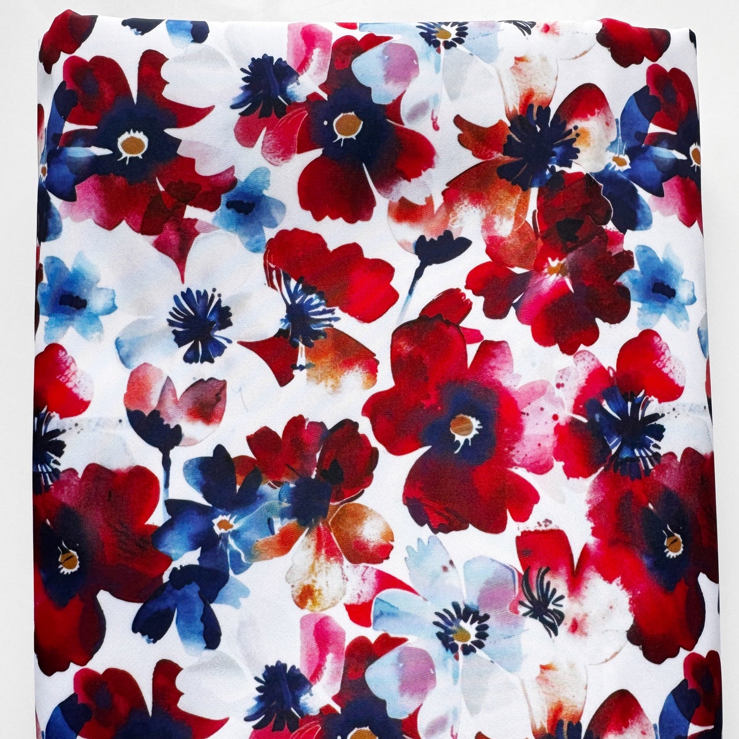 Floral fabric with red, blue, and white flowers on a white background